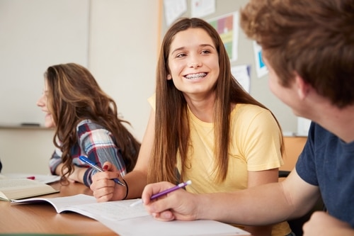 CSS Girl with braces studying in school smiling resized