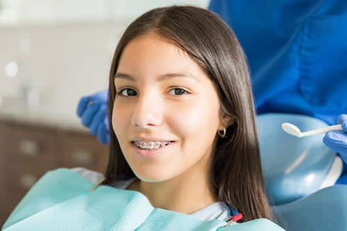 girl getting her braces checked by orthodontist RESIZED