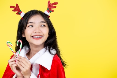 girl with braces holding candycanes RESIZED